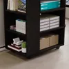 A close-up view of a dark brown rolling shelf unit filled with various items. Náhled obrázku produktu