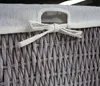 Close-up of a woven basket with a fabric lid and tie. Náhľad obrázku produktu