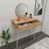 A vanity table with a mirror and makeup items on top and in an open drawer. Produktbild-Vorschau
