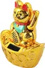 A golden lucky cat figurine sits on a base of gold coins. Produktbild-Vorschau