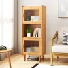 A wooden cabinet with glass doors and shelves, filled with books and a plant, placed next to a chair and a small table. Produktbild-Vorschau