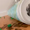 A close-up of a cleaning roller with green debris on a wooden floor. Produktbild-Vorschau