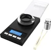 A digital milligram scale with accessories on a white background. Podgląd zdjęcia produktu
