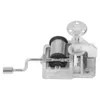A close-up studio shot of a music box mechanism. Voir les images du produit