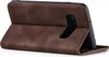 A brown flip cover case for a smartphone is shown from the side, with the cover open to reveal the back of the phone. Produktbild-Vorschau