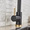 A close-up view of a black kitchen faucet with gold accents, set against a white brick backsplash and a countertop. Produktbild-Vorschau