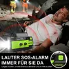 A person is lying on the ground in a collapsed structure, with rescuers in the background. A solar radio is in the foreground, with red sound waves emanating from it. Produktbild-Vorschau