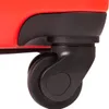 A close-up of a black suitcase wheel and a portion of the red suitcase body. Produktbild-Vorschau