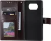 A brown leather flip case for a phone, open to show card slots and a phone holder. Produktbild-Vorschau
