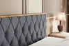 Close-up of a tufted dark gray velvet headboard with a wooden trim, part of a bed. Produktbild-Vorschau