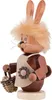 A wooden Easter bunny figurine holding a basket of eggs. Produktbild-Vorschau
