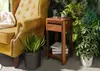 A side table next to a chair with plants. Anteprima dell’immagine prodotto