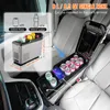 A car's interior with a portable car refrigerator installed in the center console, showcasing its capacity and features. Produktbild-Vorschau