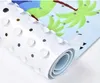 A close-up, rolled-up view of a bath mat with a cartoonish palm tree design. Produktbild-Vorschau