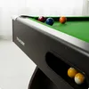 A close-up view of a billiard table with several balls on the green felt surface. Podgląd zdjęcia produktu
