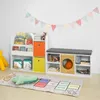 A children's room with a bookshelf, storage bench, and a hopscotch rug. Produktbild-Vorschau