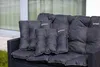 Close-up of dark gray outdoor cushions on a dark gray wicker sofa. Produktbild-Vorschau