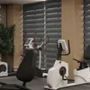 A gym interior with exercise equipment and blinds. Voir les images du produit