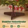 Close-up of a Christmas tree stand with gifts in the background. Produktbild-Vorschau