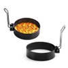 Two black metal egg rings with silver handles, one with an omelet inside. Náhled obrázku produktu