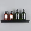 Four pump bottles of soap or lotion are displayed on a black shelf against a gray wall. Náhľad obrázku produktu