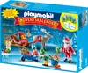 A Playmobil advent calendar box depicting Santa Claus, elves, a reindeer, and a sleigh with presents in a snowy forest setting. Produktbild-Vorschau