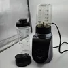 A blender base with two containers and a lid, set against a reflective background. Anteprima dell’immagine prodotto