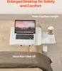A laptop and a cup are placed on a white bedside table, which is positioned over a bed. Podgląd zdjęcia produktu