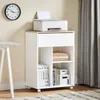 A white printer stand with a printer on top, placed in a room with a clock on the wall and curtains in the background. Podgląd zdjęcia produktu