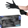 A person putting on black nitrile gloves, with a box of the gloves in the foreground. Náhled obrázku produktu