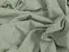 A close-up view of crumpled light green fabric, likely a bedsheet. Anteprima dell’immagine prodotto