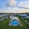 A residential neighborhood with houses and a covered swimming pool. Produktbild-Vorschau