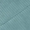 A close-up shot of a teal-colored corduroy fabric with a diagonal seam dividing the image. Produktbild-Vorschau
