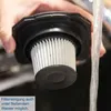 A hand is holding a vacuum cleaner filter under running water, indicating cleaning. Anteprima dell’immagine prodotto