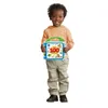 A young child holding a toy book. Voir les images du produit