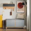 An entryway with a shoe bench, coat rack, umbrella stand, and artwork. Náhled obrázku produktu