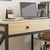 A close-up view of a desk with a laptop, books, and a calendar. Náhľad obrázku produktu