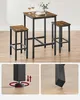 A vintage-style bar table set with two stools, placed on a wooden floor. Náhled obrázku produktu