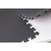 A close-up view of interlocking gray foam floor mats on a white surface. Produktbild-Vorschau
