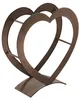 A metal firewood rack shaped like a heart on a white background. Produktbild-Vorschau