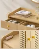 Collage of images showing details of a wooden furniture piece, likely a dresser or sideboard, with drawers and cabinet doors featuring rattan inserts. Produktbild-Vorschau