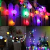Collage of images showing colorful LED string lights in various settings, including draped over a fence, indoors near a fireplace, and in decorative bottles. Produktbild-Vorschau
