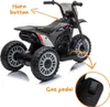 A three-wheeled electric toy motorcycle, a Honda CRF450 replica, shown from a three-quarter rear view against a white background. It has orange text labels pointing to the horn button and gas pedal. Anteprima dell’immagine prodotto
