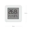 A small white digital thermometer and hygrometer displaying temperature and humidity readings, with dimensions indicated. Podgląd zdjęcia produktu