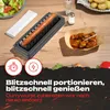 A kitchen scene showing a device for slicing sausages, with sliced sausage in a tray and prepared currywurst in a paper boat. Produktbild-Vorschau