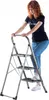 A woman is standing on a step stool. Podgląd zdjęcia produktu
