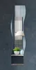 A decorative mirror with a shelf, a plant, and a vase. Produktbild-Vorschau