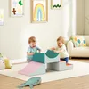 Two babies playing with soft foam building blocks in a nursery or playroom. Anteprima dell’immagine prodotto