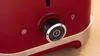 A close-up shot of the control panel of a red toaster. Voir les images du produit
