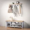 A hallway set with a shoe bench, coat rack, and accessories. Voir les images du produit